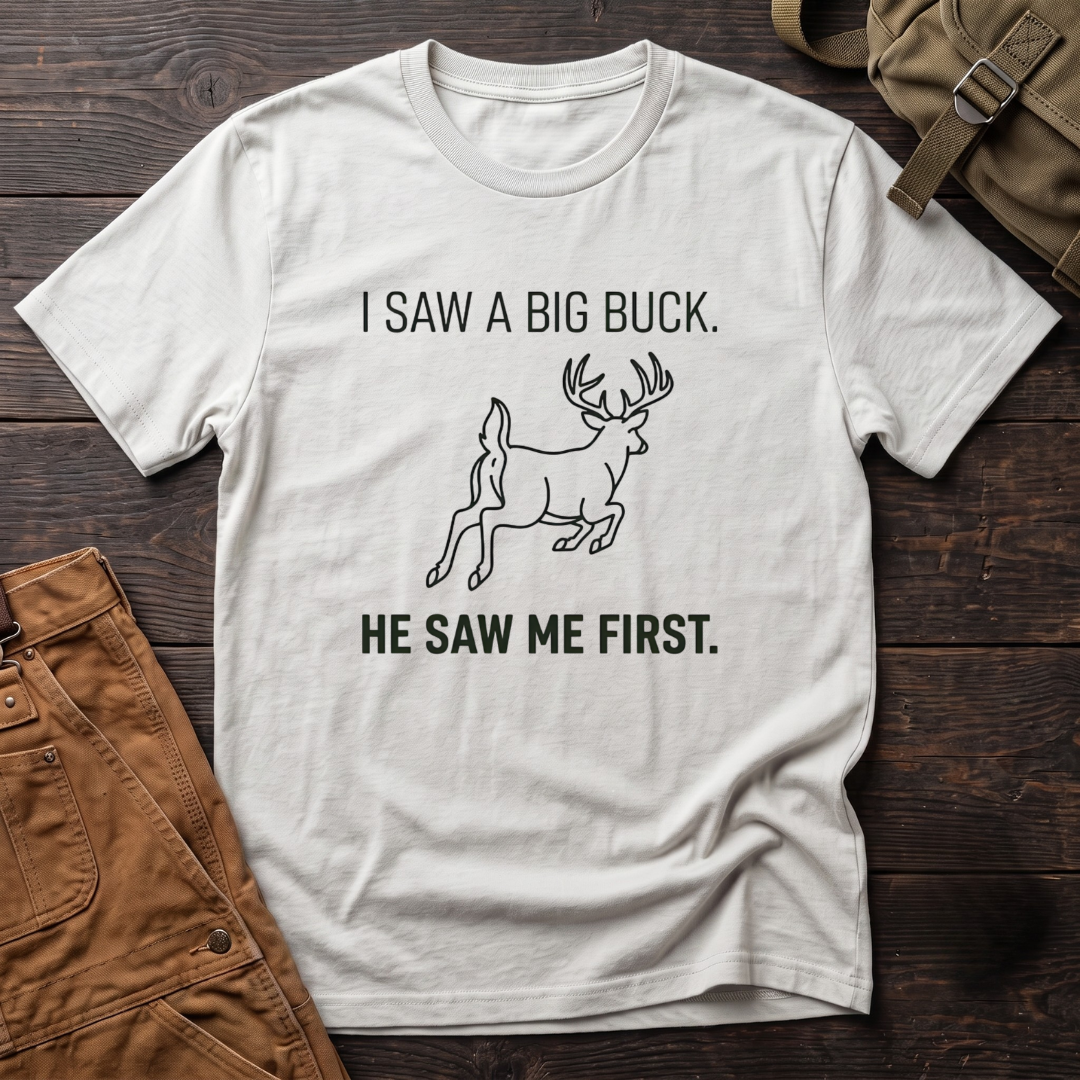 White funny deer hunting t-shirt with I Saw A Big Buck, He Saw Me First text and a line-art whitetail buck bounding away