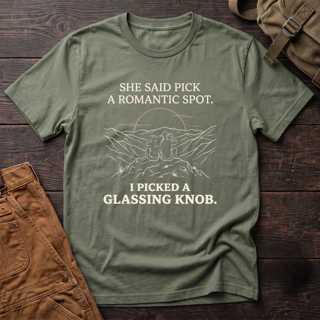 Military Green funny hunting t-shirt with She Said Pick A Romantic Spot, I Picked A Glassing Knob text and a line-art couple glassing from a ridge at sunset