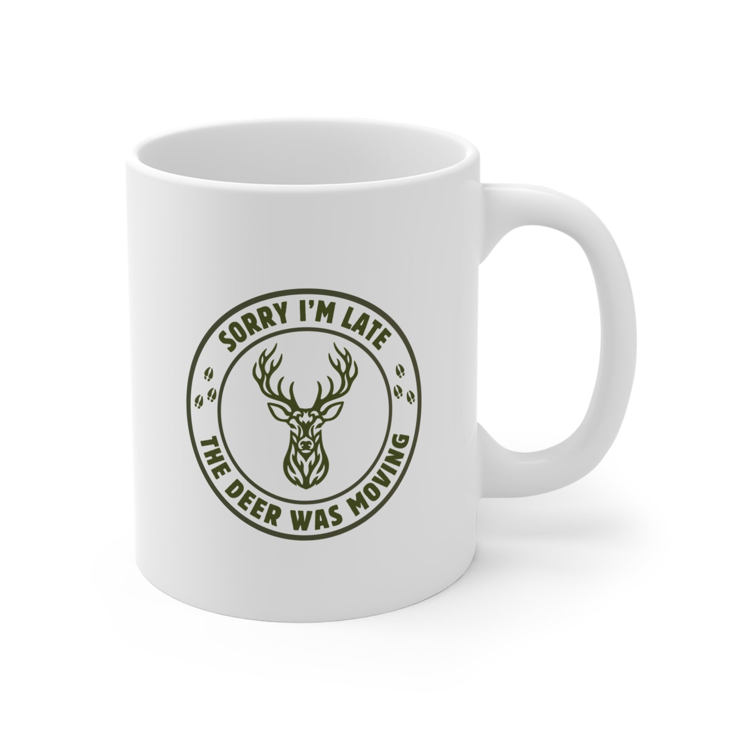 White 11 oz ceramic deer hunting mug with Sorry I'm Late the Deer Was Moving circular slogan and whitetail deer head graphic, shown from the right side on a white background.