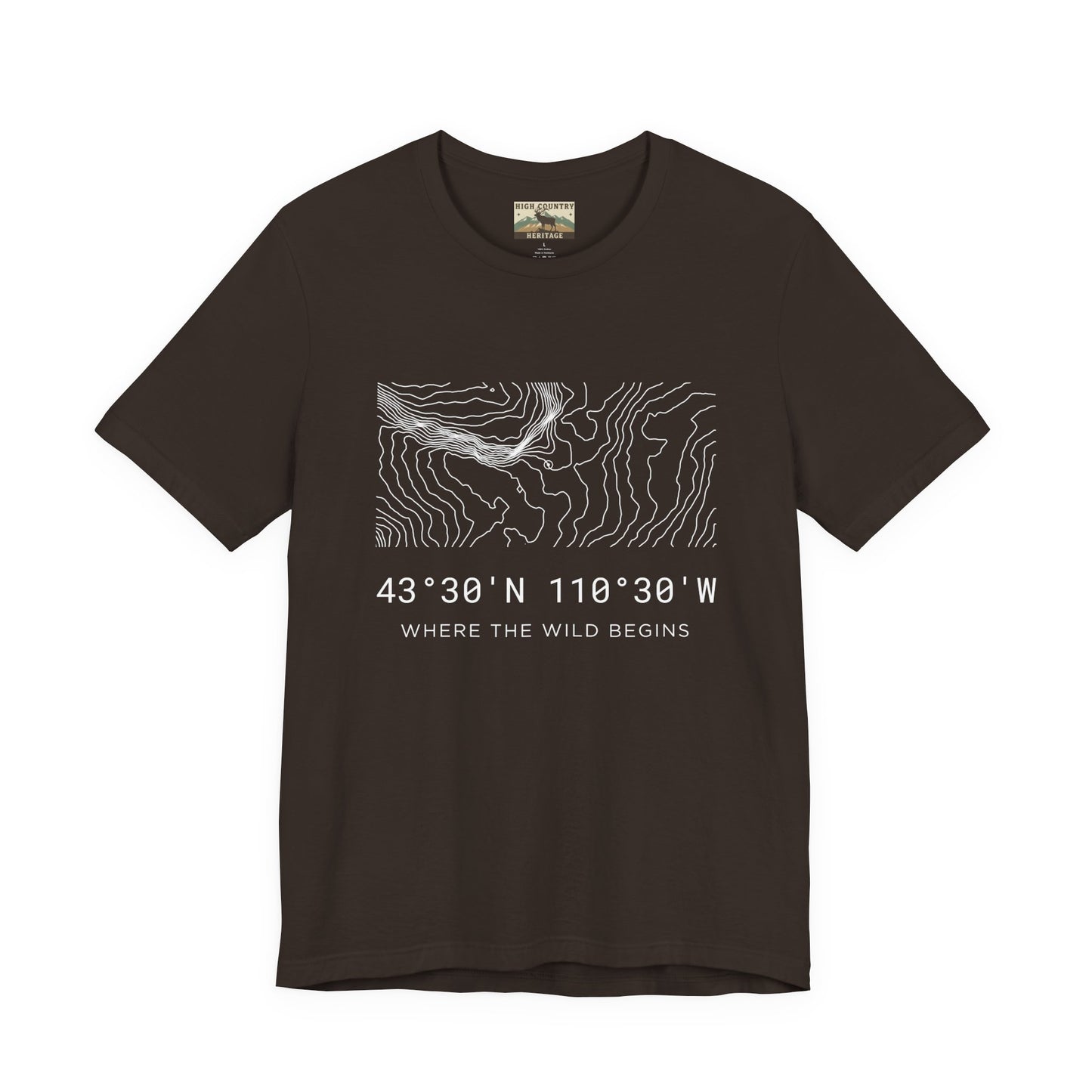 High Country Heritage Wyoming elk hunting topo t-shirt in Brown, displaying the minimalist Bridger-Teton contour map design and the tagline Where the Wild Begins on a flat product mockup.