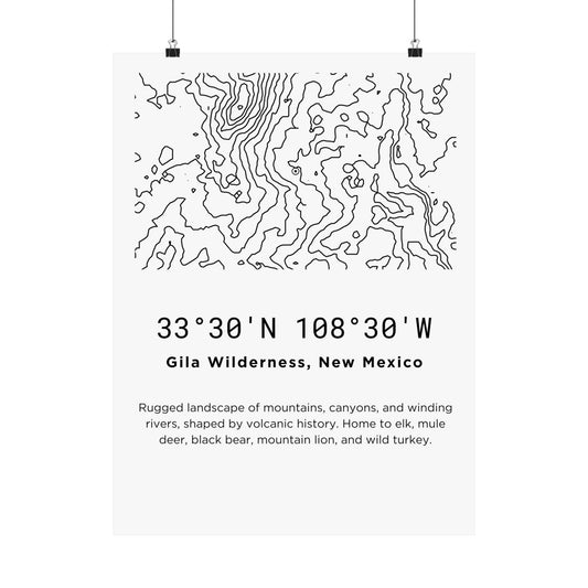 Full flat view of the Gila Wilderness New Mexico minimalist topographic map poster hung with binder clips, displaying the fragmented canyon-country contour line art, coordinates, and wildlife description text on off-white matte paper.