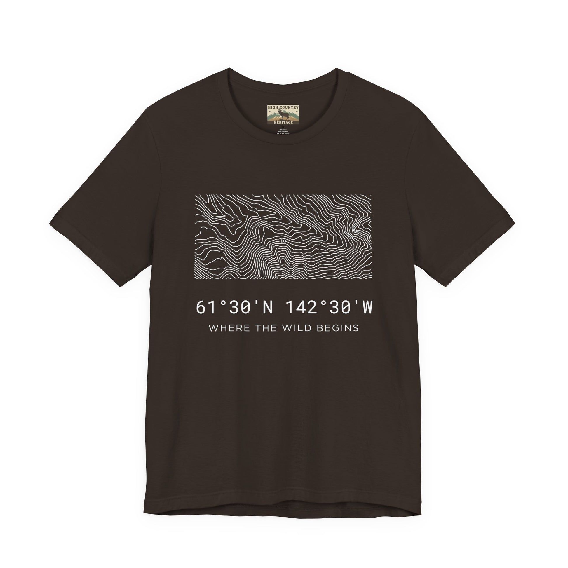 High Country Heritage Wrangell-St. Elias topo t-shirt in Brown, displaying the minimalist Alaska contour map design and the tagline Where the Wild Begins on a flat product mockup.