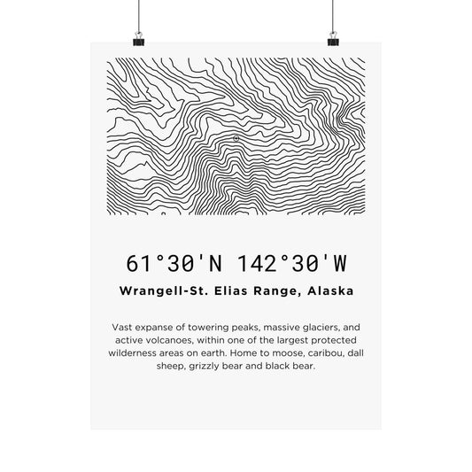 Full flat view of the Wrangell-St. Elias Range Alaska minimalist topographic map poster hung with binder clips, displaying the sweeping contour line art, coordinates, and wilderness territory description on off-white matte paper.