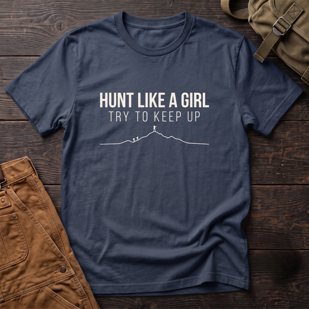 Navy women's hunting t-shirt with Hunt Like A Girl, Try To Keep Up text and a line-art mountain ridge with a hunter on the summit ahead of two hikers