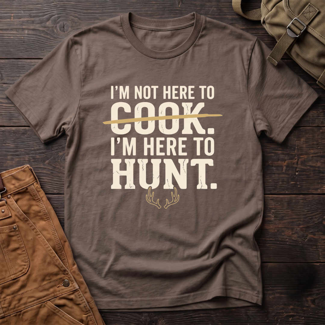 Brown funny hunting t-shirt with I'm Not Here To Cook, I'm Here To Hunt text, the word Cook crossed out, and a pair of antlers