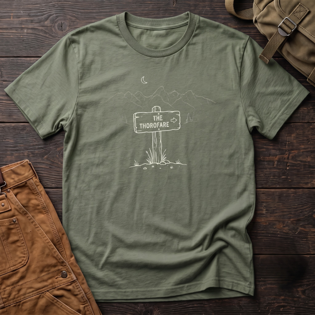 Military Green Wyoming backcountry t-shirt with The Thorofare trail sign under a line-art mountain range, pine trees and a crescent moon