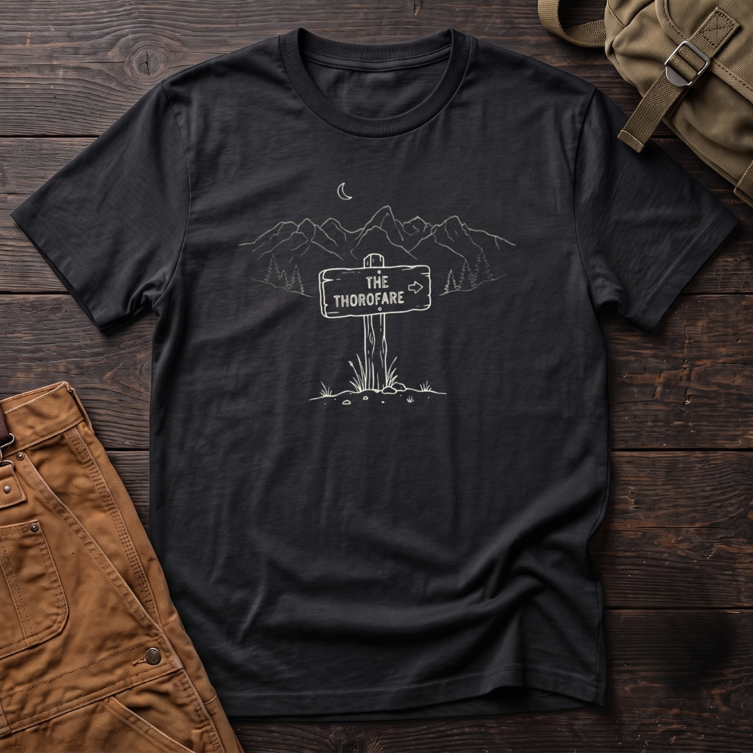 Black Wyoming backcountry t-shirt with The Thorofare trail sign under a line-art mountain range, pine trees and a crescent moon