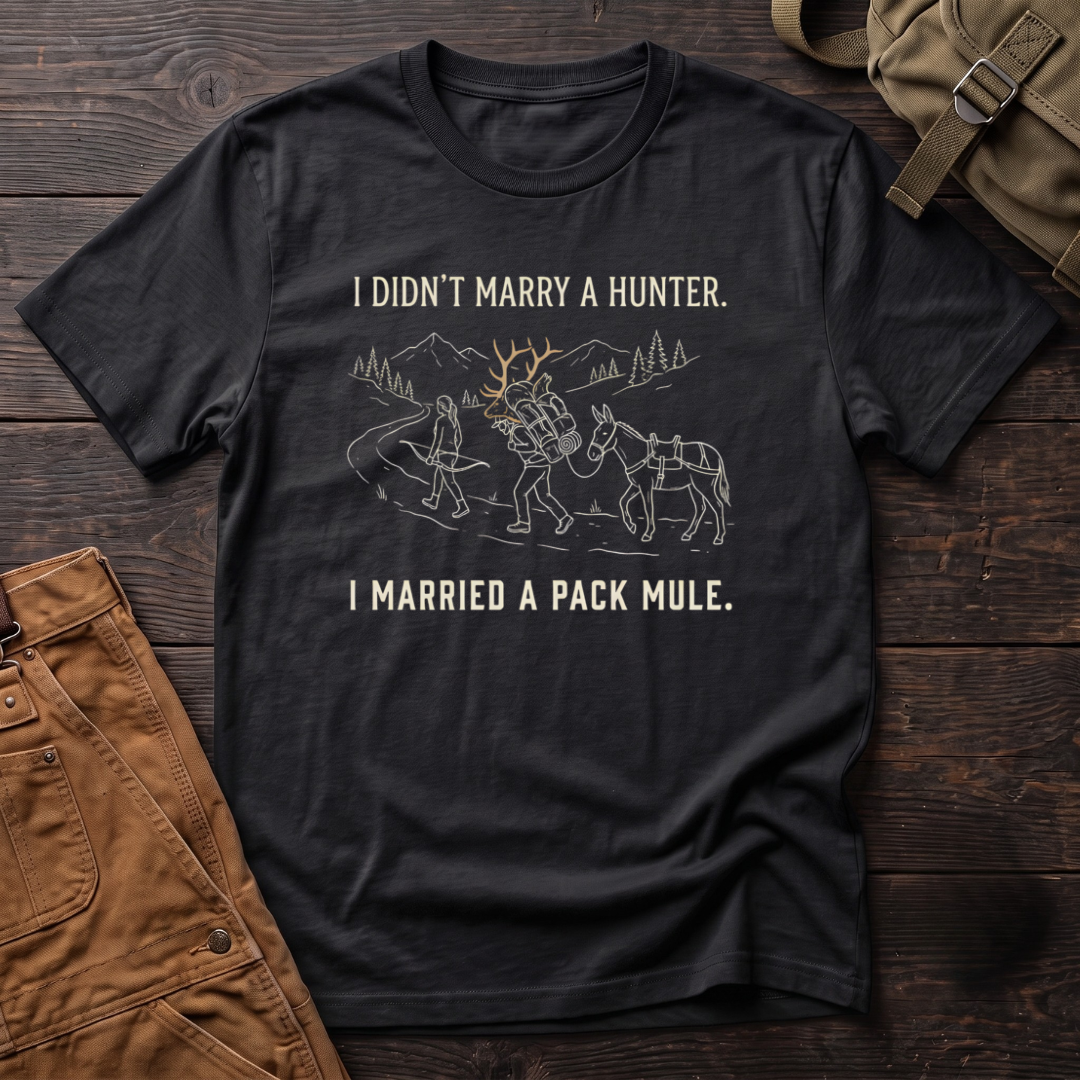 Black funny hunting t-shirt with I Didn't Marry A Hunter, I Married A Pack Mule text and a line-art bowhunter walking ahead of a partner who packs out an elk rack, next to a pack mule