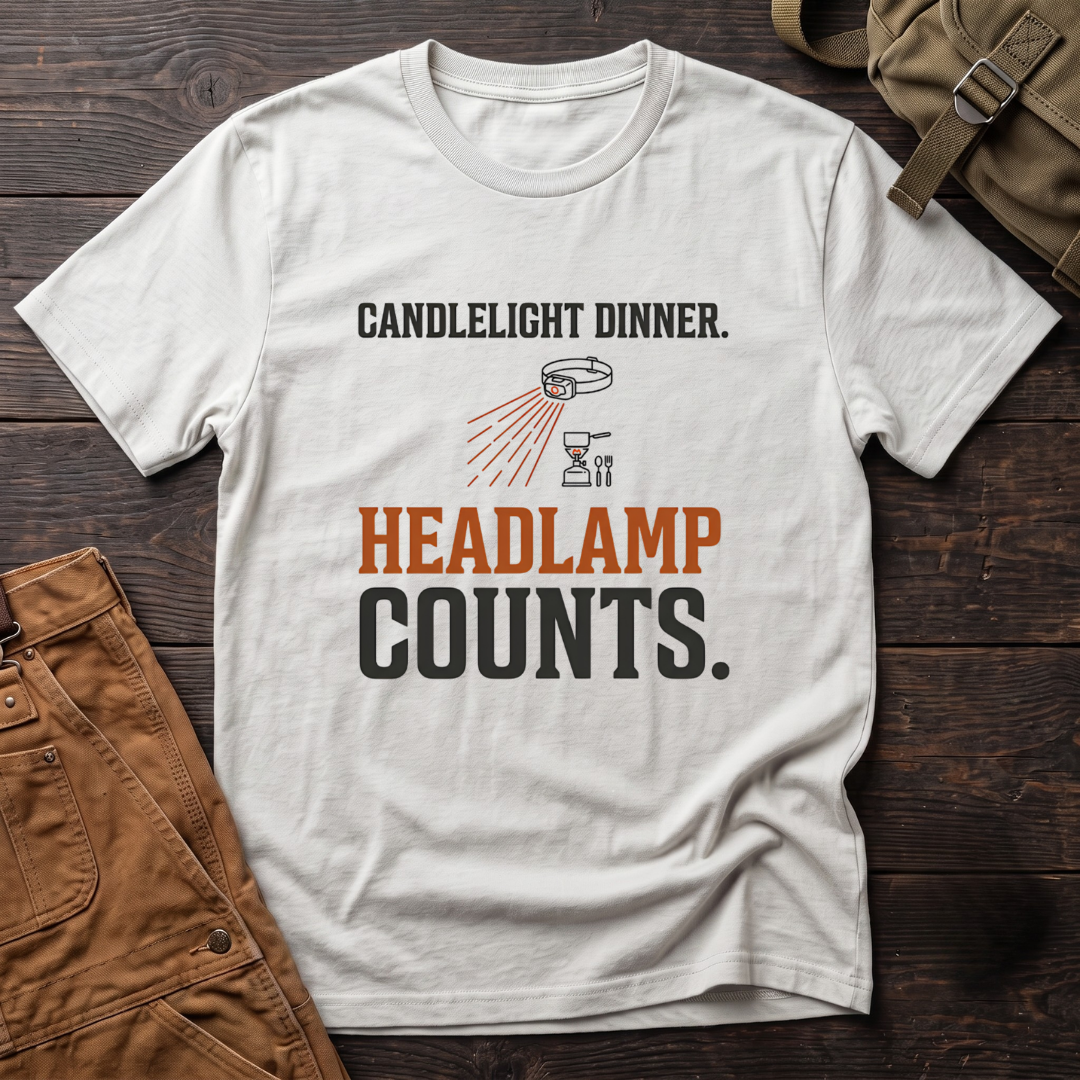 White funny hunting t-shirt with Candlelight Dinner. Headlamp Counts. text and a headlamp shining on a camp stove