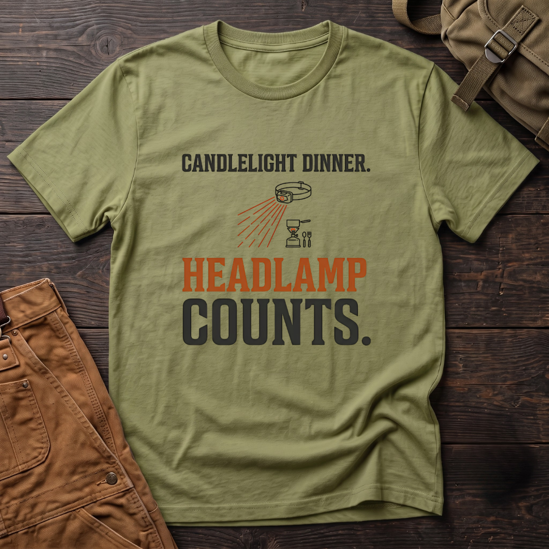 Heather Green funny hunting t-shirt with Candlelight Dinner. Headlamp Counts. text and a headlamp shining on a camp stove
