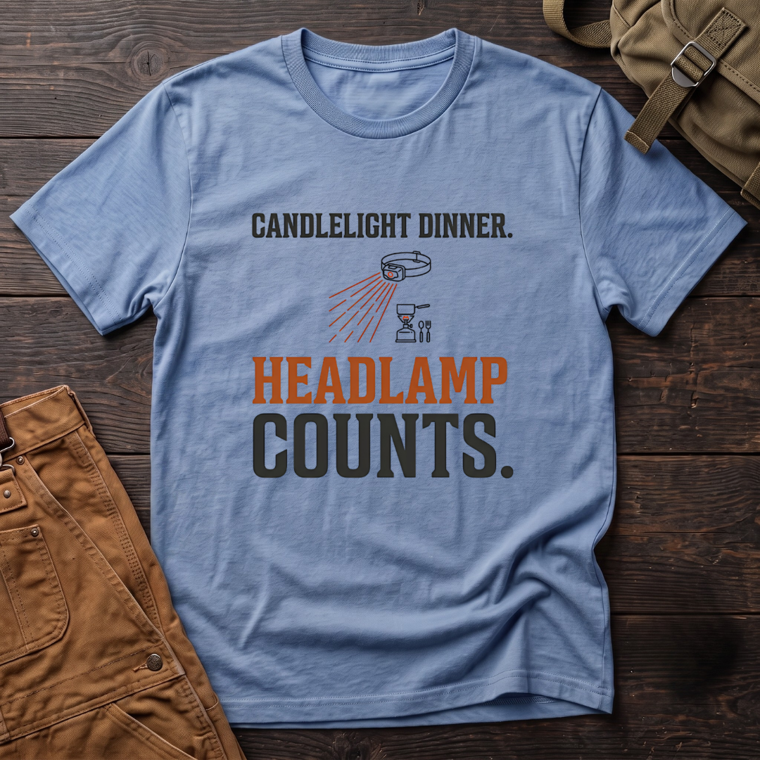 Heather Columbia Blue funny hunting t-shirt with Candlelight Dinner. Headlamp Counts. text and a headlamp shining on a camp stove