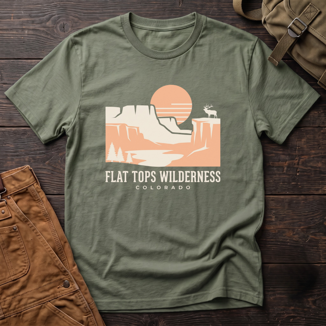 Military Green Flat Tops Wilderness Colorado t-shirt with a peach sunset over flat-topped cliffs and an elk on the rim