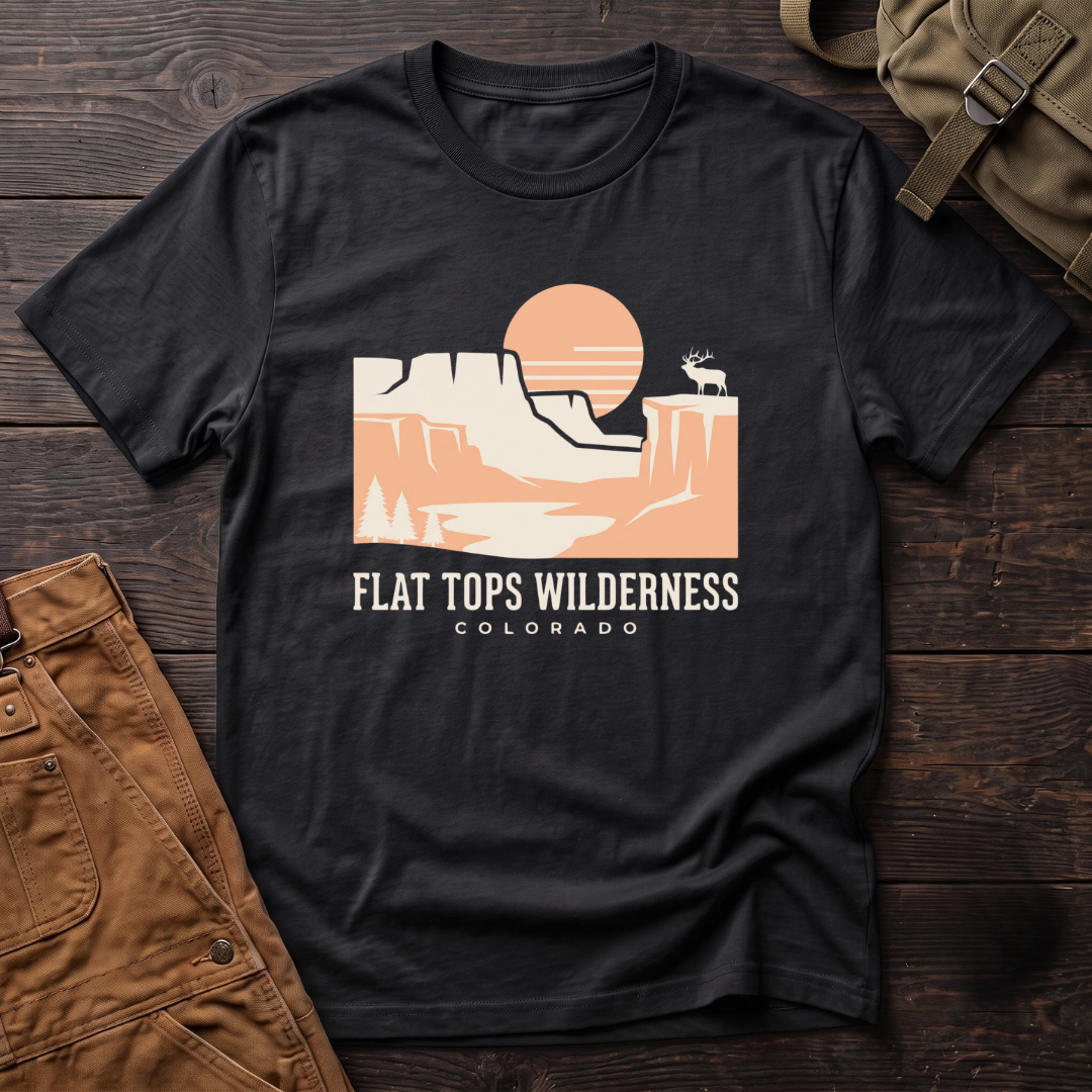 Black Flat Tops Wilderness Colorado t-shirt with a peach sunset over flat-topped cliffs and an elk on the rim