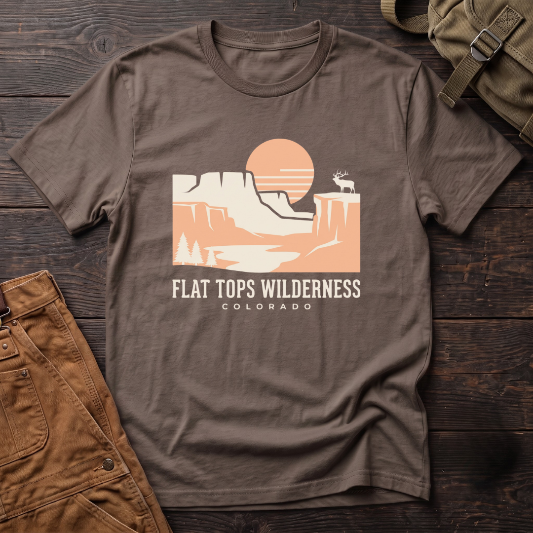 Brown Flat Tops Wilderness Colorado t-shirt with a peach sunset over flat-topped cliffs and an elk on the rim