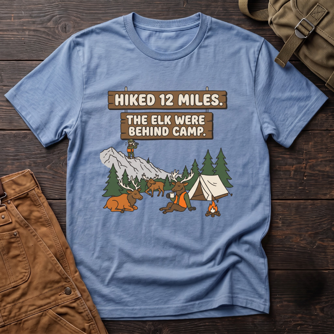 Heather Columbia Blue funny elk hunting t-shirt with Hiked 12 Miles. The Elk Were Behind Camp. signs and elk walking past a tent while the hunter glasses far away