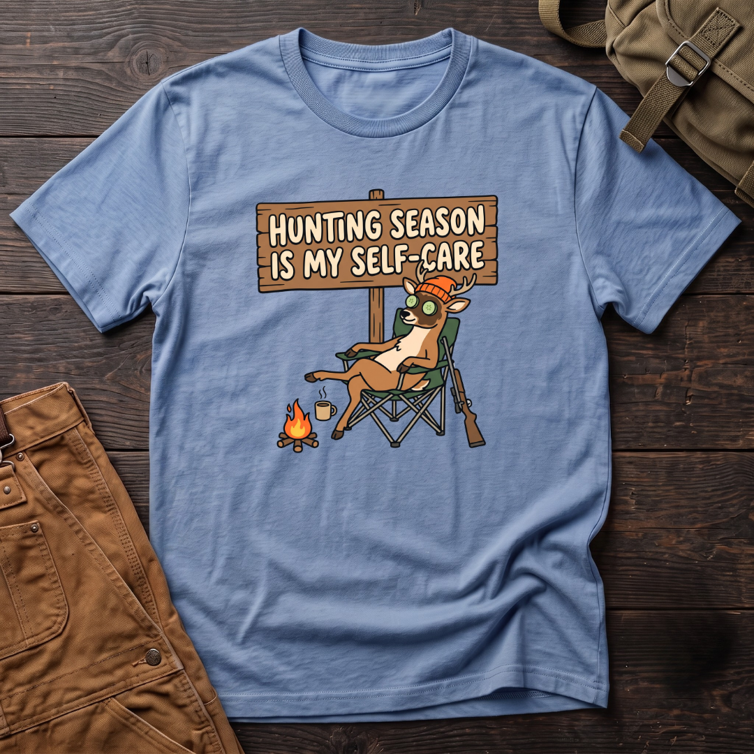 Heather Columbia Blue funny women's hunting t-shirt with a Hunting Season Is My Self-Care sign and a relaxed deer in a camp chair with a cucumber eye mask and coffee