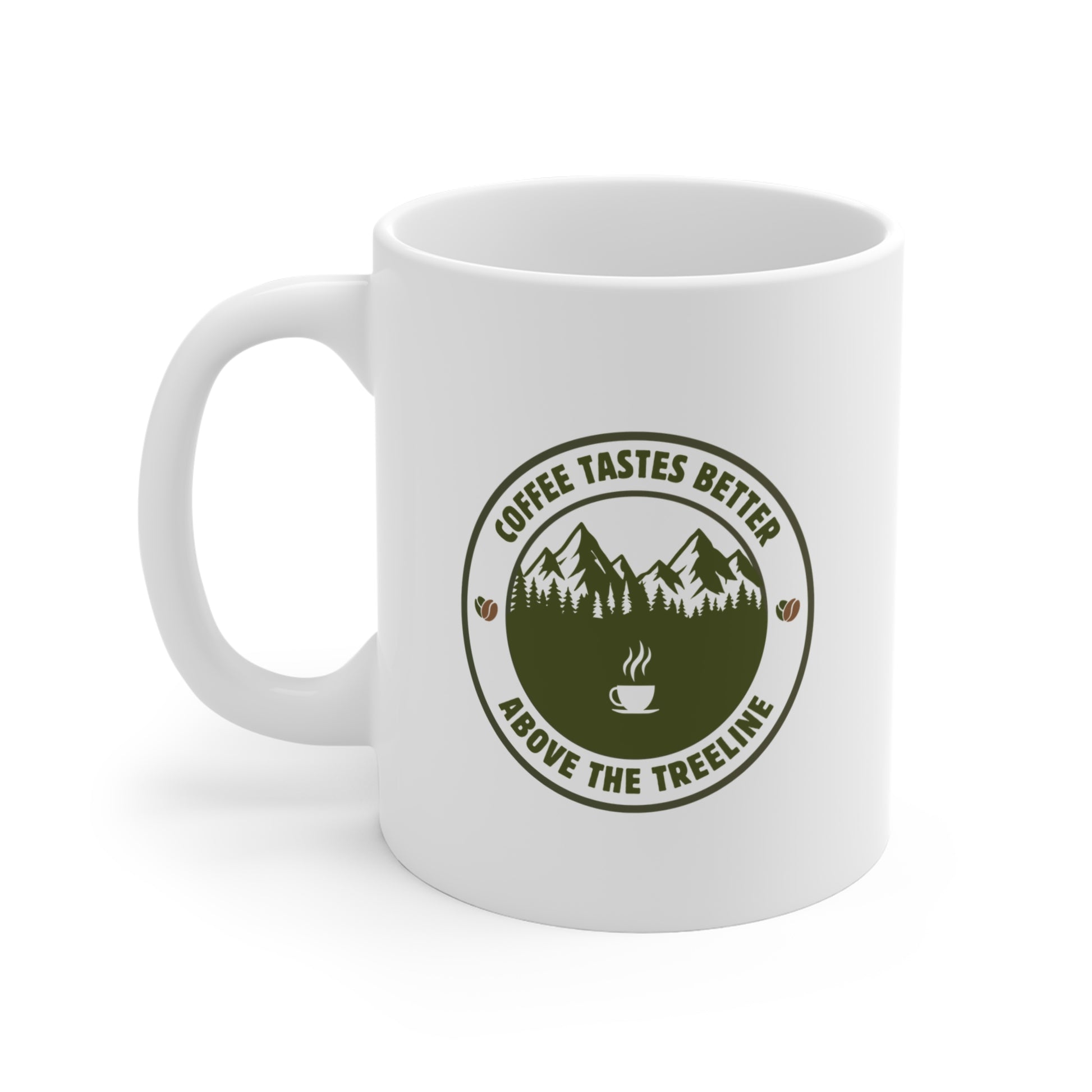 White 11oz ceramic mug on a white background showing the left side with the olive green Coffee Tastes Better Above the Treeline badge graphic and mountain treeline design.