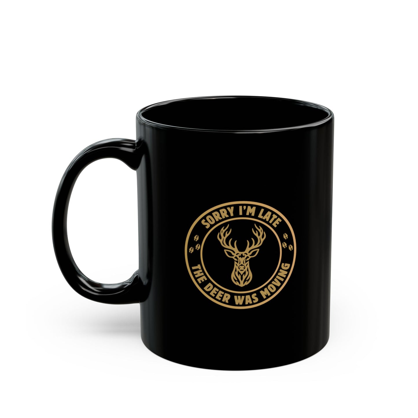 Black ceramic hunting mug with a Sorry I'm Late the Deer Was Moving badge graphic and tribal whitetail deer head in gold, shown from the left side on a white background.
