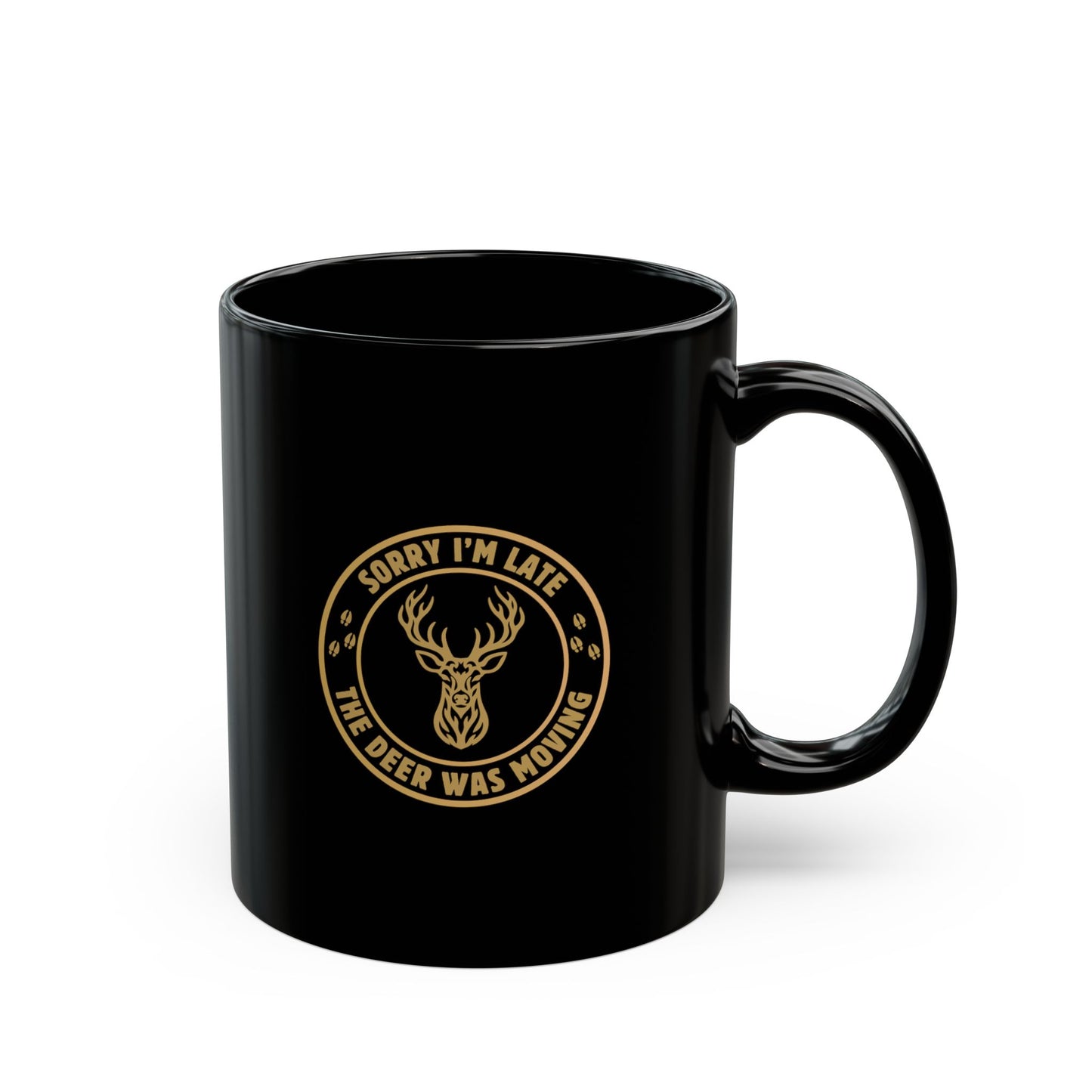 Gloss black 11 oz ceramic deer hunting mug with Sorry I'm Late the Deer Was Moving circular slogan and tribal whitetail deer graphic in gold, shown from the right side on a white background.