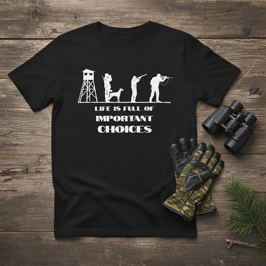 Life is Full of Important Choices hunting positions graphic tee in black laid flat on a wood surface beside camo gloves, binoculars, and a pine sprig.